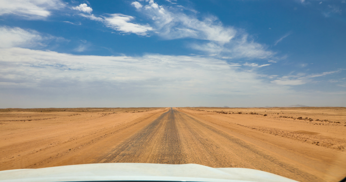 Gravel road running straight through the desert, Namibia