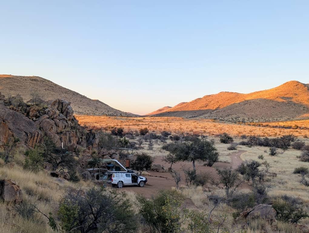 4x4 with a rooftop tent set up in a mountain valley, Namibia